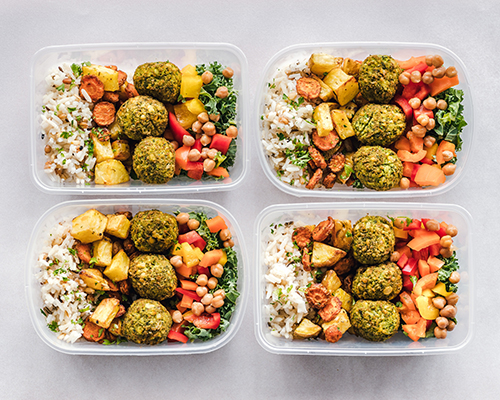four meal containers of prepared meals